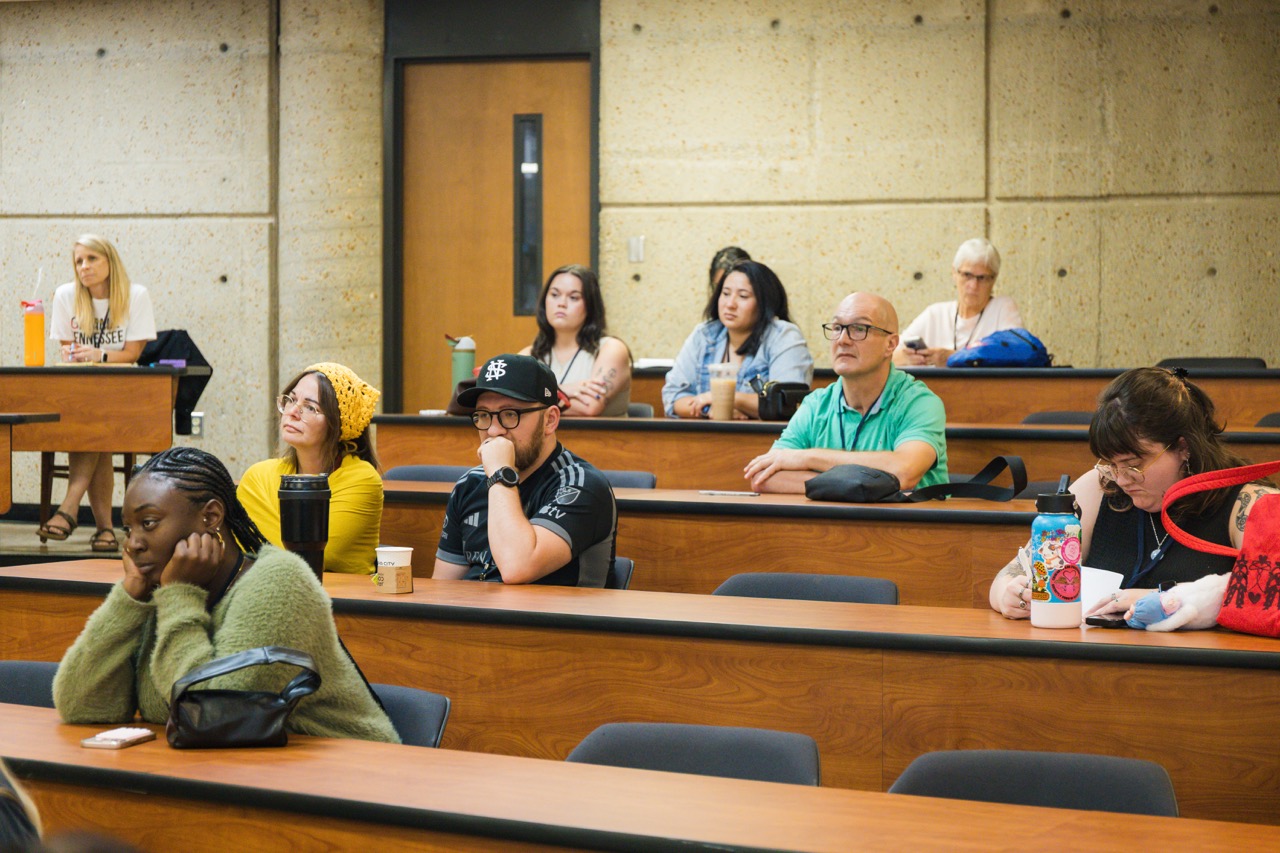 Summit participants gathered in a classroom