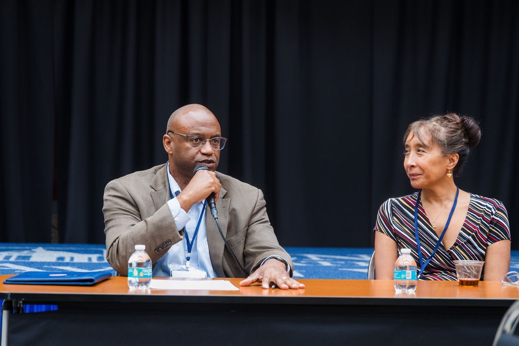 Two speakers sharing a summit panel