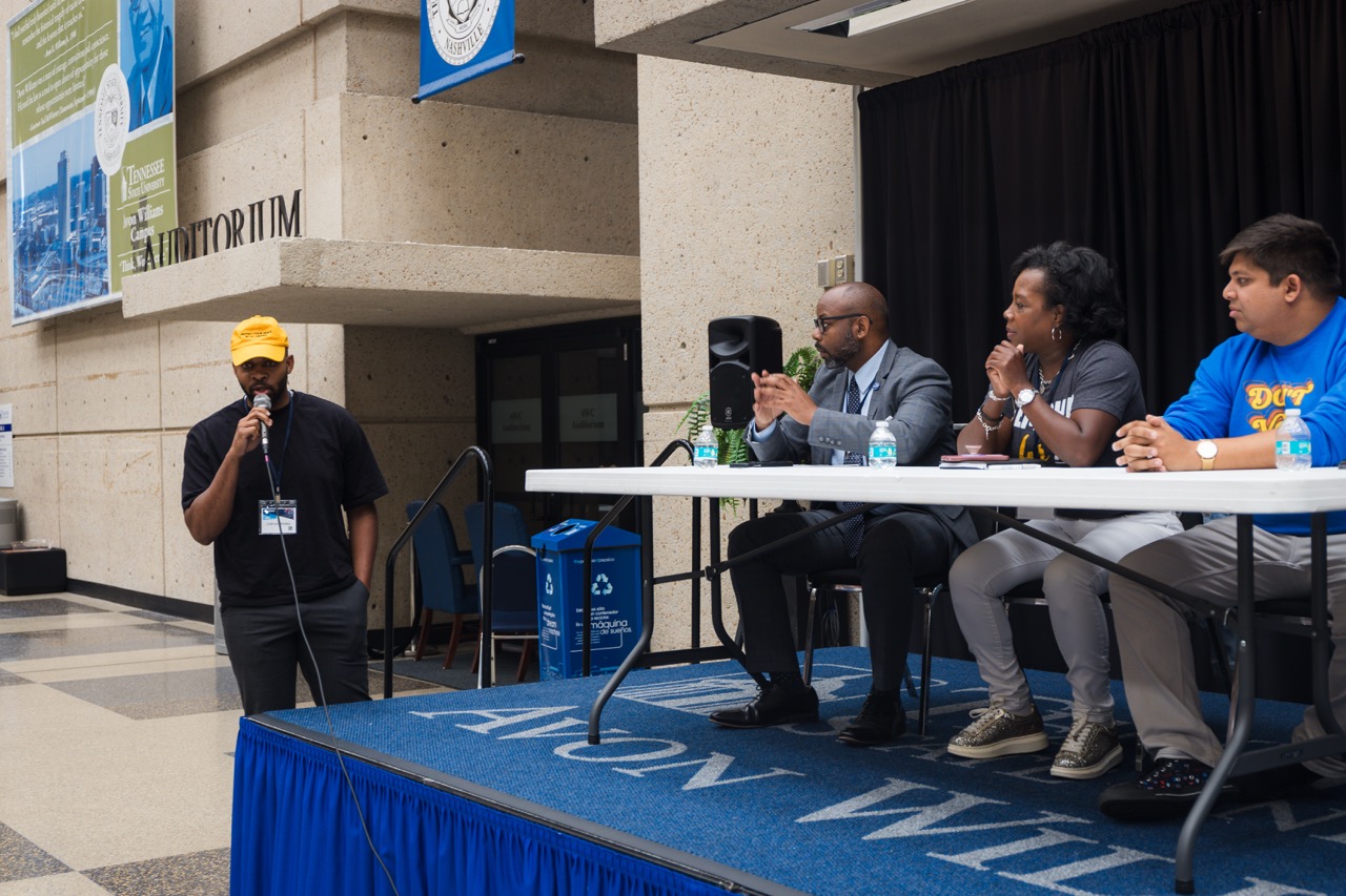 Four speakers taking part in a public panel