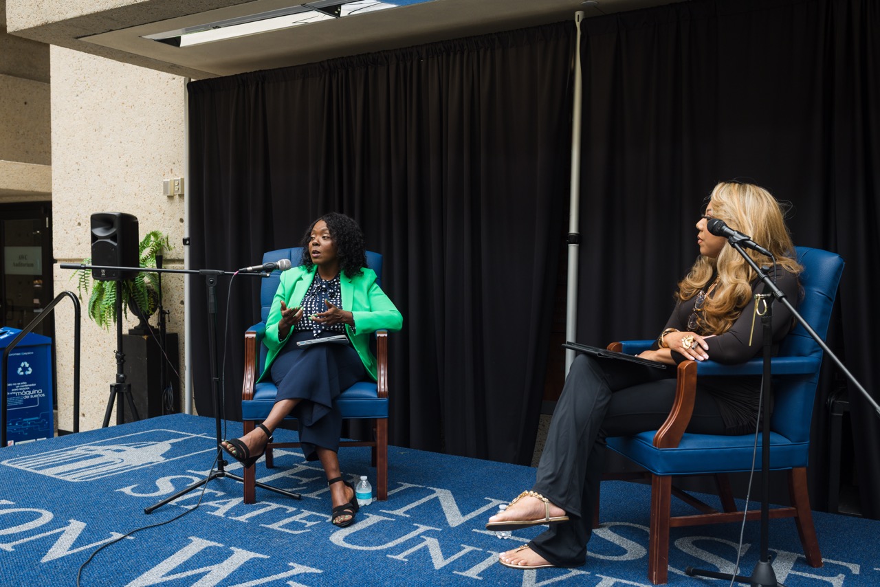Two speakers in conversation on stage